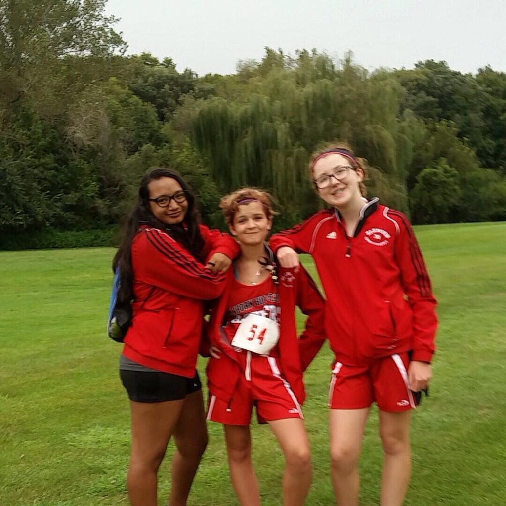 Trinity and two friends in cross country uniforms