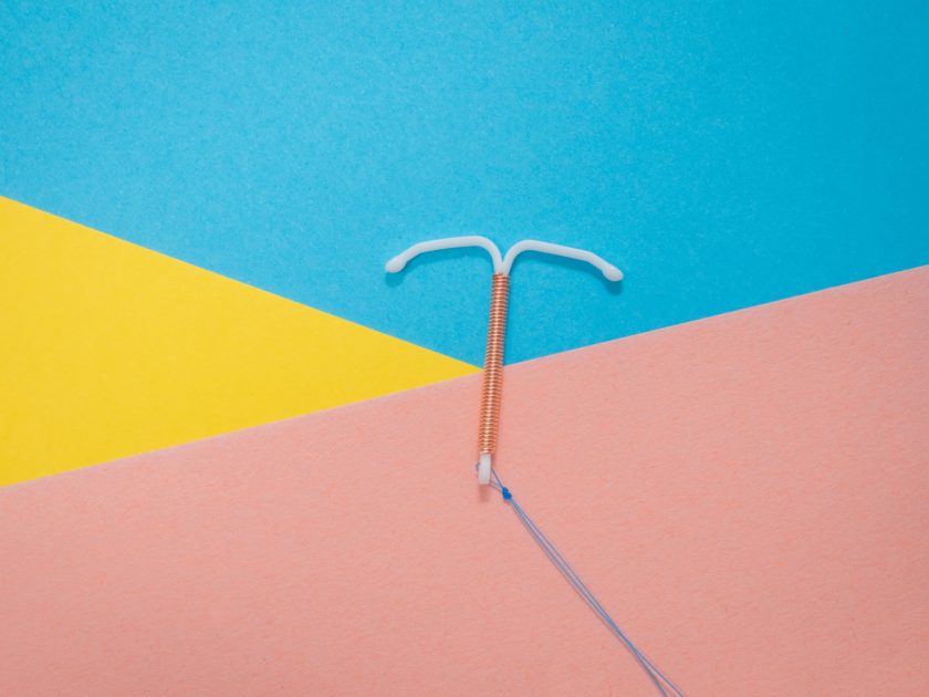 Copper IUD on a tiled background