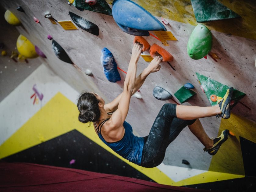 Woman indoor rock climbing